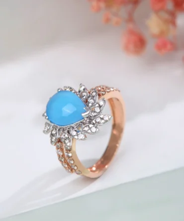 a ring with a blue stone and diamonds