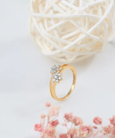 a gold ring with diamonds and a white ball of straw